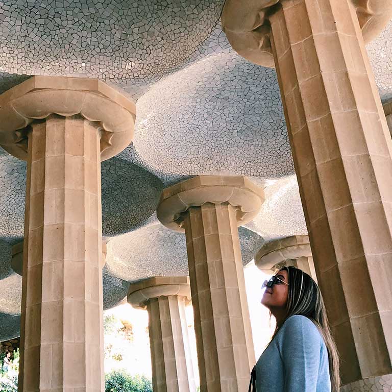 A woman looks at decorative columns.