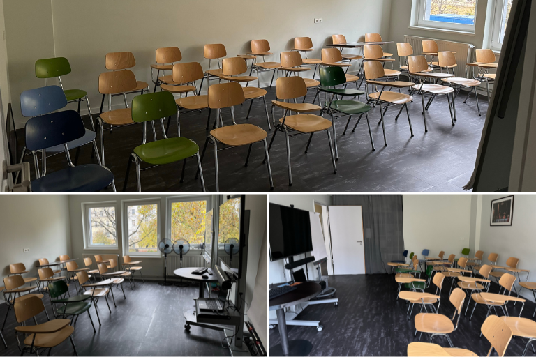 Europe Gateway classroom with 20 chairs with attached table, 4 additional regular chairs, TV screen and computer, a flipchart and whiteboard.
