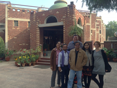Small group of people standing outside of the India gateway office.